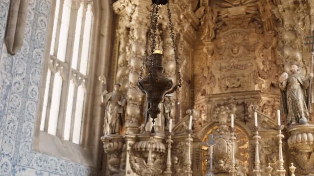 Detailed view of a cinematic golden baroque altar featuring religious statues and traditional blue azulejo wall tiles in a historic European cathedral.