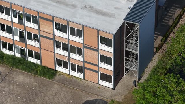 Aerial drone view of prefabricated modular housing, showing temporary homes, off-site construction, transportable units and flexible residential development.