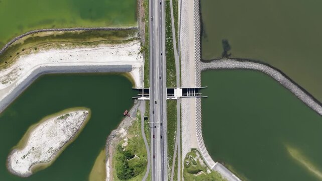 Aerial drone view of fish migration river construction at the Afsluitdijk, connecting fresh and salt water with ecological restoration, biodiversity and nature inclusive design.