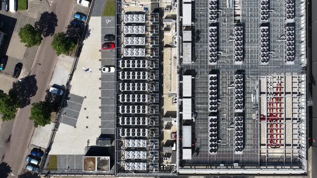 Aerial drone view of massive rooftop cooling systems on a data center, showcasing big data, colocation hardware and digital infrastructure.