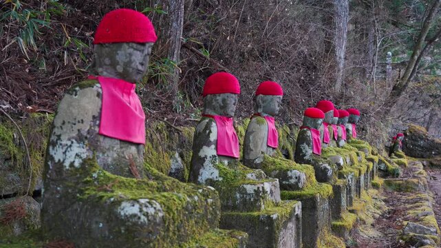 Historic row of stone Jizo statues showcasing cultural heritage, religion and centuries of devotion in Japan.