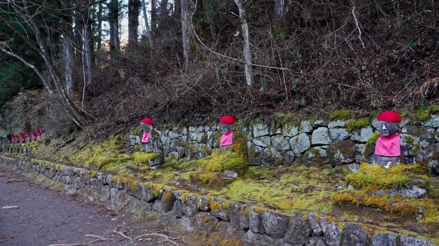 Historic Jizo guardian statues lined along the famous Kanmangafuchi Abyss pathway in Nikko, Japan.