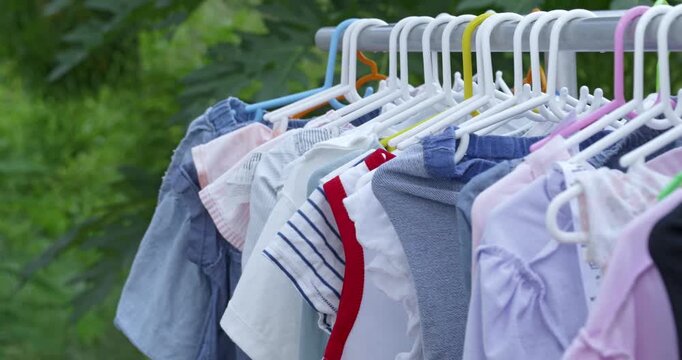Highlighting clothes drying a line outdoor garden natural light domestic life. Perfect for projects highlighting nature themes modern lifestyles and authentic environments.