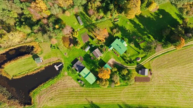 Rural homestead surrounded by fields and ponds in Rucava Parish, Latvia