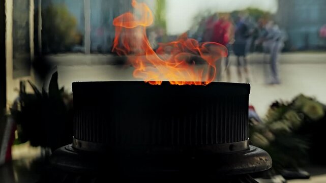 Close view showcasing an eternal flame burning at a memorial site