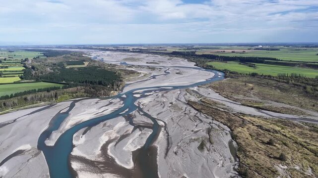 Drone view of braided river winding through Canterbury Plains of New Zealand's South Island, environment, climate and geography view.