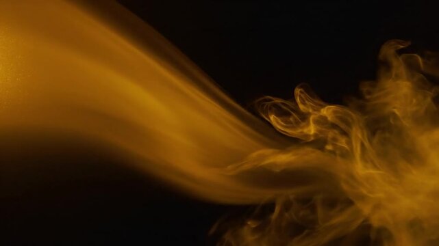 Abstract golden fluid stream and smoke against a dark background for elegant artistic effects