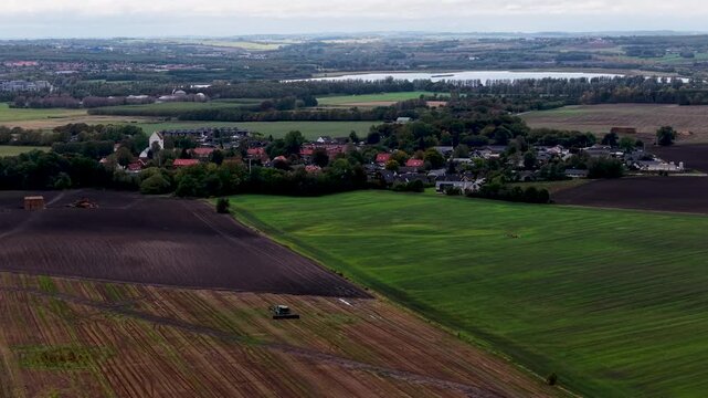 Aerial drone footage of agricultural fields and rural landscape near Eg&aring; Denmark with patchwork farmland and countryside views.