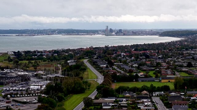 Aerial drone view of Aarhus Bay and coastal neighborhoods along the shoreline of Eg&aring; Denmark under overcast skies.