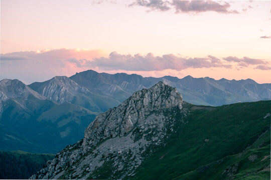 Alpine mountain scenery of Ili Valley Xinjiang China, grassland forest and rocky peaks at sunrise