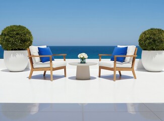 Obraz premium Modern outdoor seating area with two chairs and table overlooks serene blue ocean horizon. Two large green bushes flank white minimalist patio furniture under clear sunny sky.