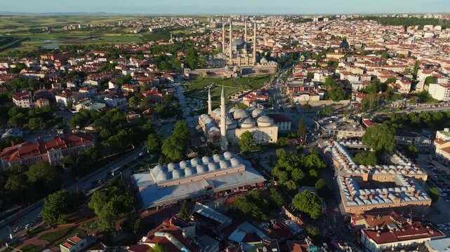 Aerial cityscape at sunset of the iconic Selimiye Mosque amidst the green parks and city streets of Edirne, Turkey.