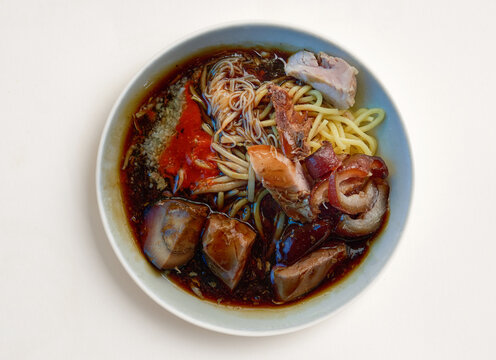 Traditional Penang Loh Mee Noodle Soup Served in Bowl isolated on white background