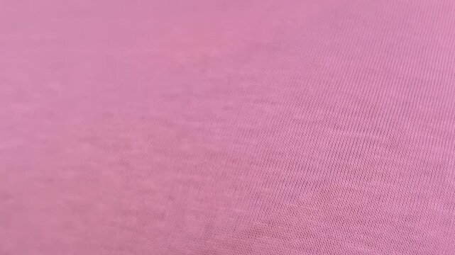 Horizontal video close up. Fat woman removes 3XL sticker from pink t-shirt. Concept of extra large size 3 XL, Black Friday sale, buying new clothes, shopping in mall shop, 11 november, weight loss