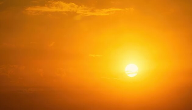 Golden Sun in Hazy Sky: A bright, intense sun shines through a hazy, golden sky, casting a warm and radiant glow across the scene.