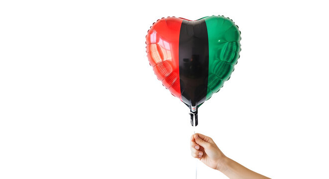 Person holds heart-shaped Juneteenth balloon with red black green colors