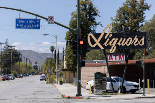 San Jacinto, California, USA - April 6, 2024: A vintage googie style sign with cursive writing decorates a liquor store in historic downtown.