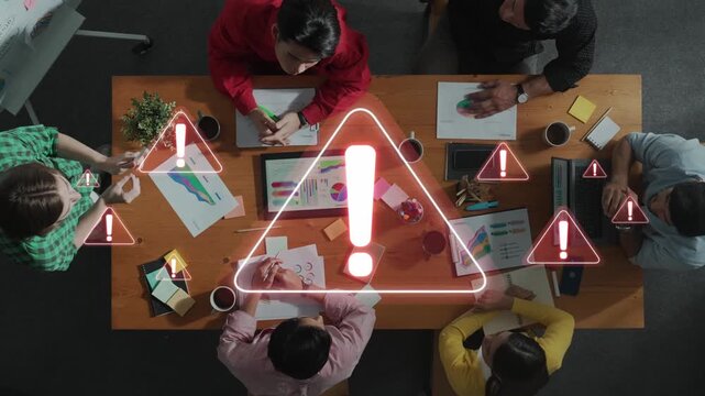 This image captures a group of professionals engaged in a brainstorming session, surrounded by warning signs that symbolize important discussions and alerts. Raster