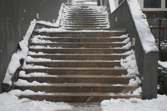 Snow covers stairs in a quiet area during winter season