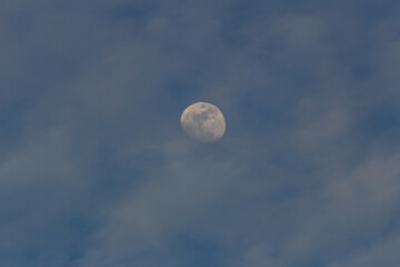 Obraz premium The moon in the sky with clouds in the evening. Toned.