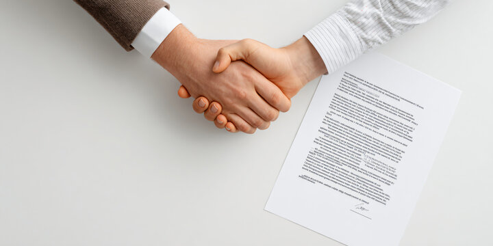 Business Handshake Over Job Offer Letter Document