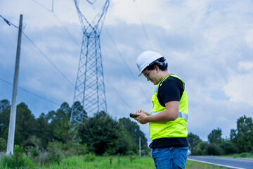 Naklejka premium Engineer checking power grid infrastructure in safety gear