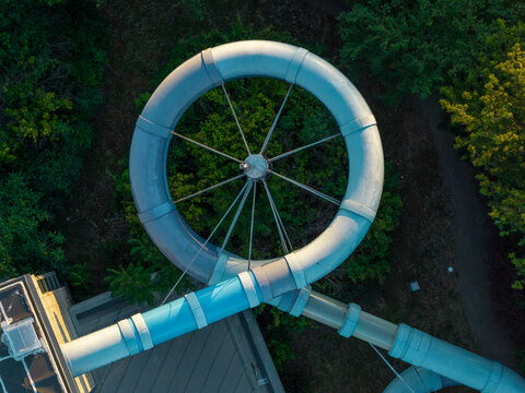 Aerial view of a circular water slide section at a swimming pool complex in Warszawa, Wojewodztwo mazowieckie, Poland.