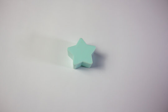Mint green star-shaped educational toy block isolated on a white background, used for children's early shape recognition and cognitive learning