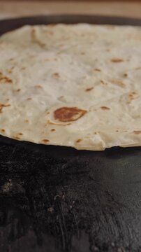 Making flatbread on a hot surface in a kitchen