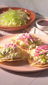 Direct flash light food video. Mexican tostadas with chicken and quesillo