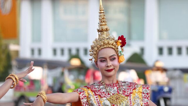Traditional Thai Khon Dancer Performing in Golden Costume on City Street