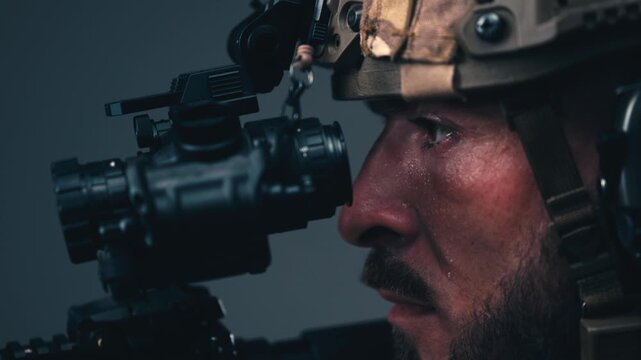 Soldier in camouflage uniform, tactical helmet and combat gear aiming a rifle. Concept military operations, combat readiness and defense.
