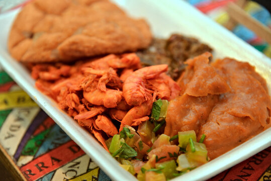 Traditional Brazilian acaraje plate with vatapa, caruru, dried shrimp and salad