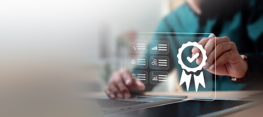 Quality assurance and ISO certification standard concept. Businessman working on laptop with digital badge icon.