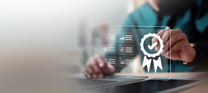 Quality assurance and ISO certification standard concept. Businessman working on laptop with digital badge icon.