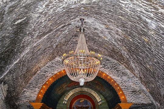 The cristal chandelier in St John&rsquo;s Chapel in Wieliczka Salt Mine underground. The words in Polish: Sit at my right hand till I make your enemy your footstool. (Bible)