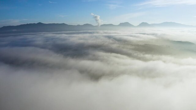 Aerial View of Thick Sea of Clouds Over Mountains at Sunrise