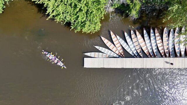 Aerial view of kayak docks and riverside recreation area surrounded by lush forest in Montreal, Canada. g.