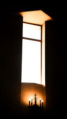 Fototapeta premium A decorative, multi‑branch metal candelabra is mounted against a warm stone wall inside the cathedral, glowing with timeless artistry.