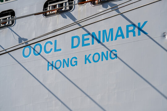 Hamburg, Germany - 4 Apr 25: OOCL Denmark ship name lettering on cargo vessel hull