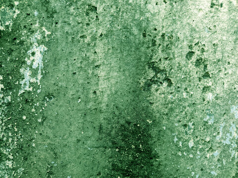 A close-up shot captures the rough, weathered texture of an old concrete wall. The surface is uneven, dark patches, mineral stains, and reflecting natural aging