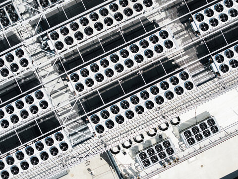 Aerial view of the EU North Riga LV DC1 data center roof, featuring rows of industrial cooling fans and ventilation systems in Riga, Latvia.