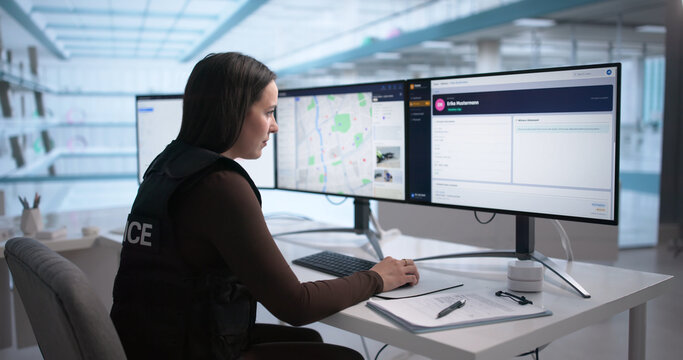 Woman Police Officer Studies Digital Case Files
