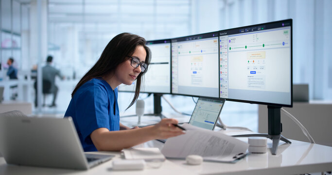 Woman Reviews Medical Billing Codes On Laptop