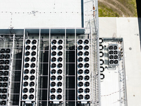 Aerial view of the industrial cooling fans and HVAC units on the roof of the EU North Riga LV DC1 data center in Riga, Latvia.