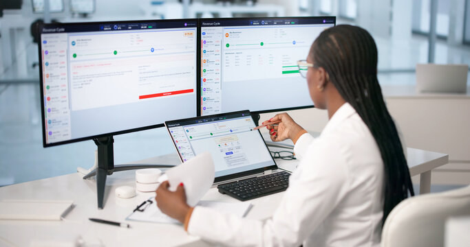 Young Woman Reviewing Medical Billing Claims On Laptop