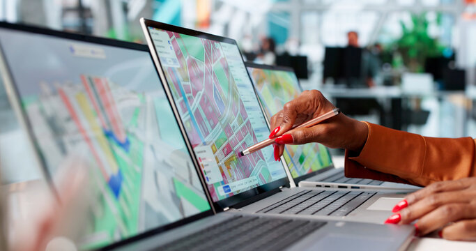 Young Woman Uses Laptop For Urban Planning