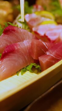 Fresh Sashimi Platter Served on Wooden Boat with Chopsticks
