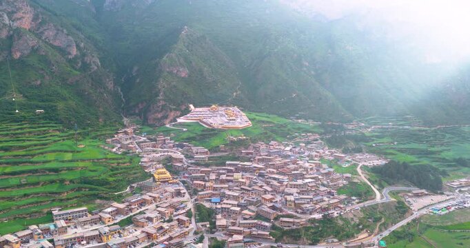 Panoramic view of Zhagana village in morning mist, Gannan Gansu, natural scenery of mountain valley with Tibetan settlements	
