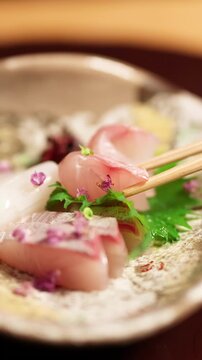 Chopsticks Picking Up Fresh Sashimi From Ceramic Plate
